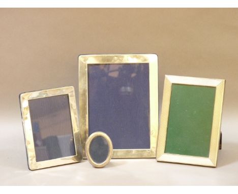 Four silver photo frames, including an engine turned example