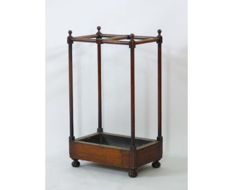 A mahogany stick/umbrella stand, with turned supports, and a tin tray, 80cm high