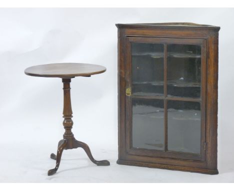 A George III oak corner cupboard, and a mahogany tripod table