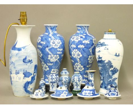 A pair of Chinese blue and white baluster vases and covers, prunus decoration, four character marks, 27cm high, two lamp base
