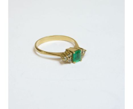 A seven stone emerald and diamond ring, tested as approximately 18ct gold, finger size K½