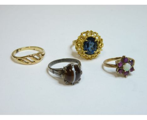 A 9ct gold opal and garnet cluster ring, a blue paste ring tested as approximately 18ct gold, a banded agate ring, and a gold