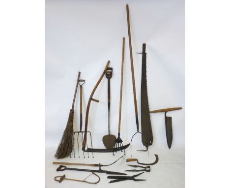 Fourteen old agricultural tools, including scythes, shears, pitchfork, etc