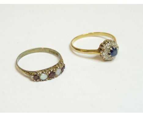 A sapphire and diamond circular cluster ring, marked 18ct, and a silver opal and garnet ring