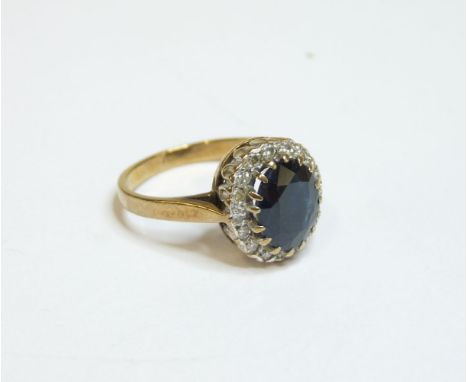 A 9ct gold oval sapphire and diamond cluster ring, finger size K