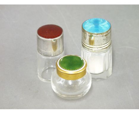 A glass scent bottle, with a red enamel and silver hinged lid and mount, London 1897, 5cm high, and two further miniature toi