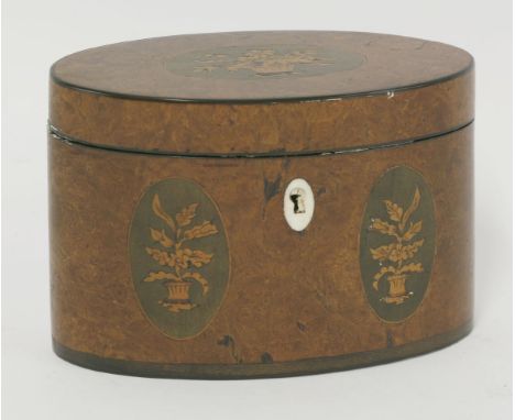 A George III burr walnut oval single compartment tea caddy, with three oval inlaid panels, each depicting a basket of flowers