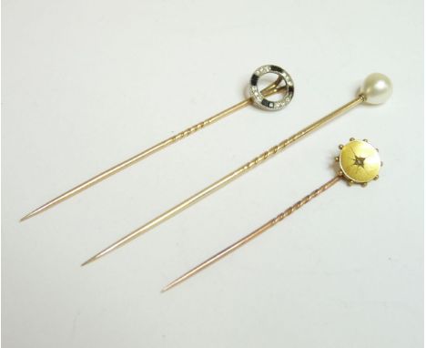 A pear shaped pearl, untested, mounted as a gold stick pin, an Art Deco diamond and calibré black stone circle stick pin, one