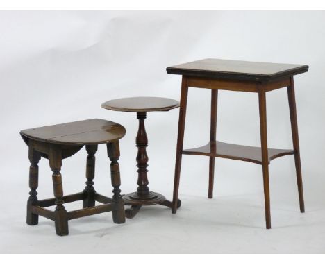 An Edwardian strung mahogany fold over card table, 55cm, a mahogany tripod table, and an oak drop leaf stool