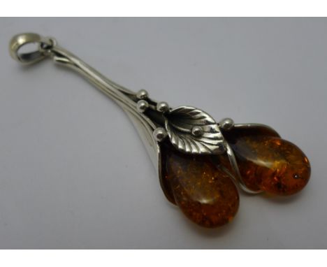 An Art Nouveau style amber dress pendant 