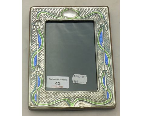 An Art Nouveau style sterling silver and enamel photograph frame