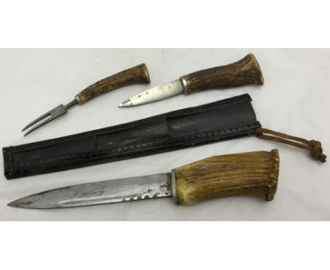 A Continental hunting knifeThe steel blade with antler handle, the metal backed leather sheath incorporating a knife and fork
