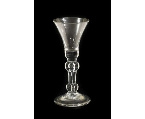 A Wine Glass, circa 1730, the bell-shaped bowl on inverted baluster stem with air tear and basal knop with folded foot16.5cm 