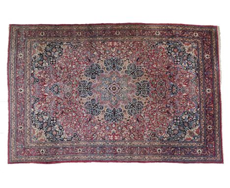 Mashhad CarpetNorth East Iran, circa 1920The strawberry field of scrolling vines and a pink medallion framed by blue spandrel