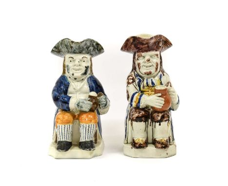 A Prattware Toby Jug, circa 1800, of traditional form, the seated figure holding a jug of ale25cm highA Similar Jug, the figu