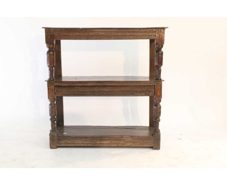 A Charles I Oak Court Cup-Board or Buffet, 2nd quarter 17th century, the boarded top above a punch-ground frieze and baluster