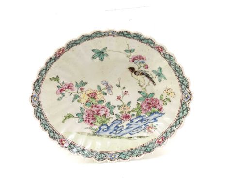A Chelsea Porcelain Small Dish, circa 1752-53, of fluted oval form, painted in Yongzheng famille rose style with a bird perch