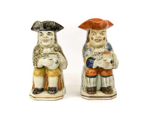 A Prattware Toby Jug, circa 1800, of traditional form, the seated figure holding a jug of ale 24.5cm highA Similar Toby Jug24