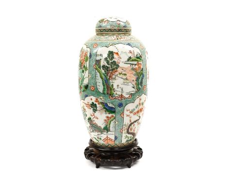 A Chinese Porcelain Vase and Cover, in Kangxi style, of ovoid form, painted in famille verte enamels with a landscapes, mythi