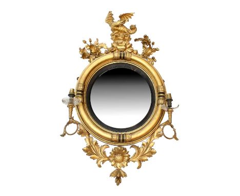 A Regency Gilt and Gesso Circular Convex Mirror, early 19th century, with ebonised and reeded slip within a moulded acanthus 