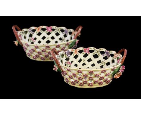 A Pair of Worcester Porcelain Yellow Ground Baskets, circa 1775, of oval form with crabstock handles, painted with flowerspra