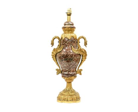 A French Gilt Metal Mounted Variegated Marble Lamp Base, in Louis XVI style, of baluster form with dragon handles, on fluted 