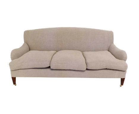 A Late 19th Century Deep-Seated Three-Seater Sofa, in the manner of Howard &amp; Sons, recovered in light grey linen, with ro