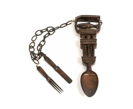 A Welsh Treen Love Spoon, 19th century, the rotating terminal carved with a fish and hung with a knife and fork attached by t