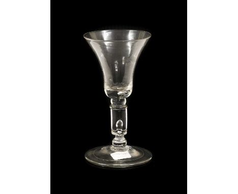 A Wine Glass, circa 1730, the bell-shaped bowl with air tear to solid base, on a balll knop and cylindrical knop with air tea