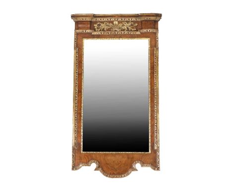 A George II Style Walnut and Parcel Gilt Wall Mirror, 19th century, the mercury bevelled glass plate within a stiff leaf carv