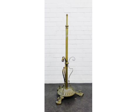 Early 20th century adjustable brass standard lamp on a circular base with tree ornate feet.
