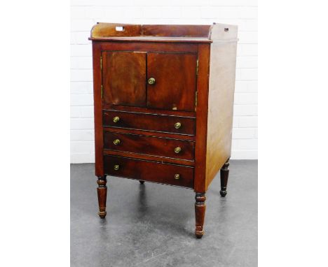 Georgian mahogany commode, the tray top with handles to the side over a pair of cupboard doors and three graduating drawers, 