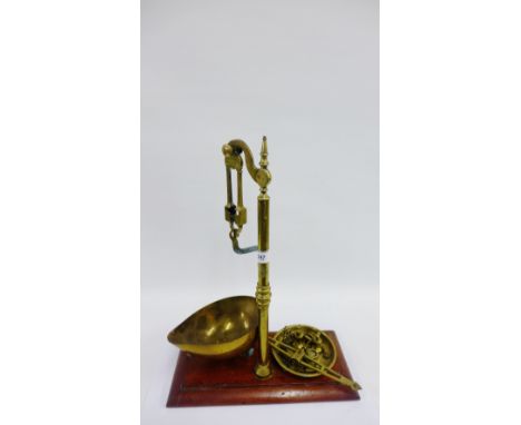 Set of brass scales on a rectangular mahogany base, together with miscellaneous weights