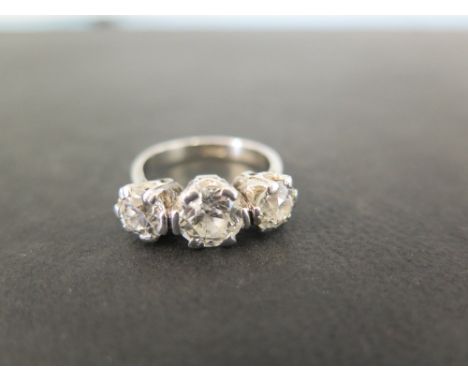 An early 20th century platinum diamond three-stone ring  - The graduated old-cut diamonds to the tapered diamonds and plain b