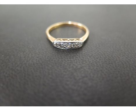 An early 20th century gold diamond ring - The old-cut diamond panel to the plain band - Tests as higher carat gold - Ring siz