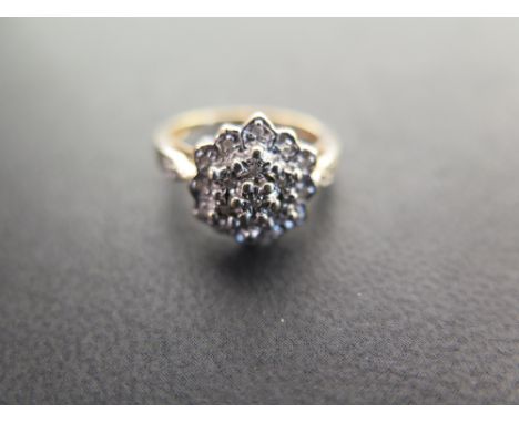 A 9ct gold diamond cluster ring - Diamond weight 0.10ct, stamped to band - Partial hallmark - Ring size L - Weight approx 3.5