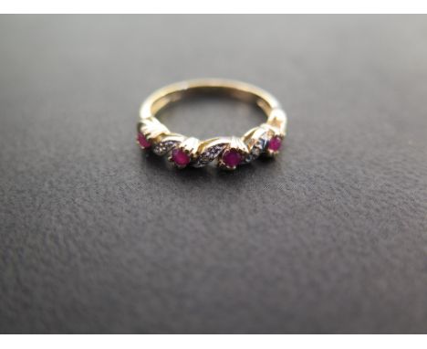 A 9ct gold ruby and diamond twist ring - Hallmarked Sheffield - Ring size M - Weight approx 2.1gms
Condition Report: Good