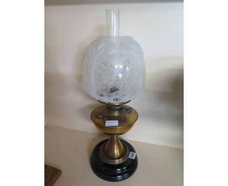 An Edwardian brass oil lamp with an opaque molded and etched Art Nouveau shade