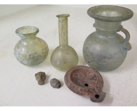 Three pieces of Ancient glass possibly Roman - Height 10cm, 9 cm and 7 cm with an earthenware oil lamp, a scarab and lions he