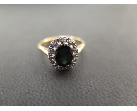  An 18ct gold sapphire and diamond cluster ring - Hallmarked London - Ring size L - Weight approx 3.8gms
Condition Report: Go