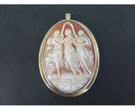 A shell cameo pendant/brooch - Depicting ladies dancing, within aplain 9ct gold surround - Hallmarked Sheffield - Length 7.5c