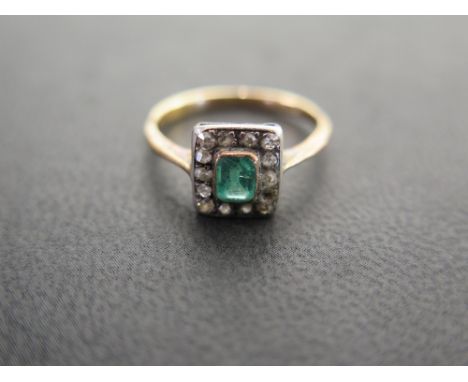 An early 20th century emerald and old-cut diamond cluster ring - To the later band - Tests as high carat gold - Ring size M -