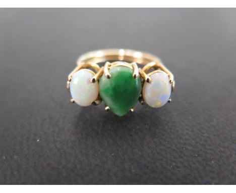 A bespoke jade and opal three-stone ring - To the openwork band - Tests as 9ct gold - Ring size O - Weight approx 3.5gms
Cond