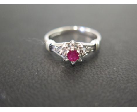 A 9ct gold ruby and diamond cluster ring - Hallmarked London - Ring size I - Weight approx 1.9gms
Condition Report: Good - Wi