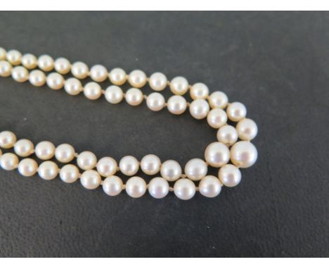 A graduated cultured pearl two-row necklace - To the yellow stone and seed pearl cluster clasp - Length approx 44cms 
Conditi