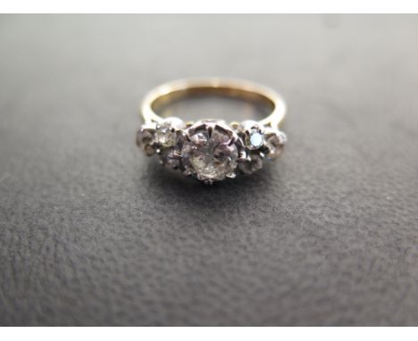 A diamond dress ring - The brilliant-cut diamond within an illusion setting to the vari-cut diamond trefoil shoulders and pla
