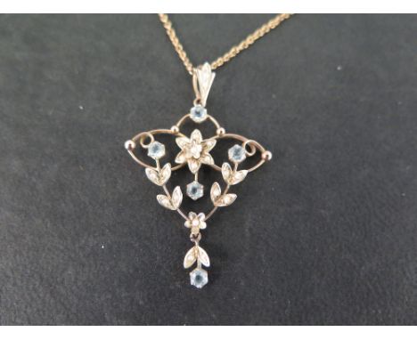 An early 20th century 9ct gold seed pearl and aquamarine pendant - Suspended from a 9ct gold belcher-link chain - Length of p