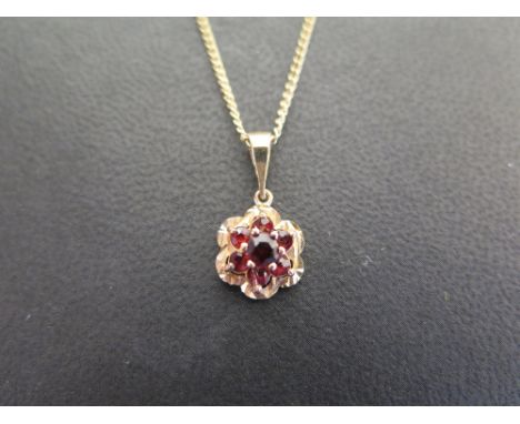 A 9ct gold garnet cluster pendant - Suspended from a curb-link chain - Hallmarked Birmingham - Length of pendant 2cms - Lengt