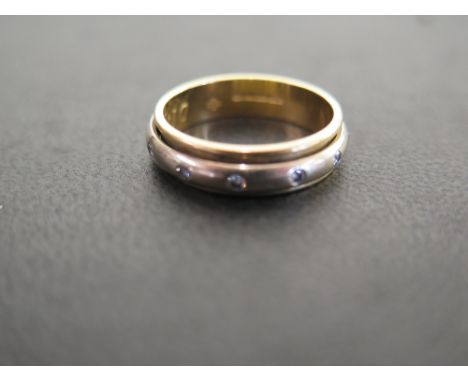 An 18ct gold diamond full-circle revolving band ring - Hallmarked London - Ring size P - Weight approx 5.6gms
Condition Repor