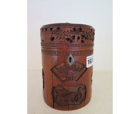 A Chinese carved 19th century Bamboo bitong type tea caddy with hinged lid and a fruit/floral knop, the caddy is decorated wi